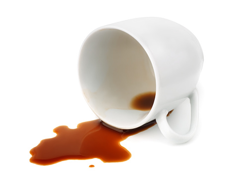 Fallen coffee cup with spilled coffee isolated on white